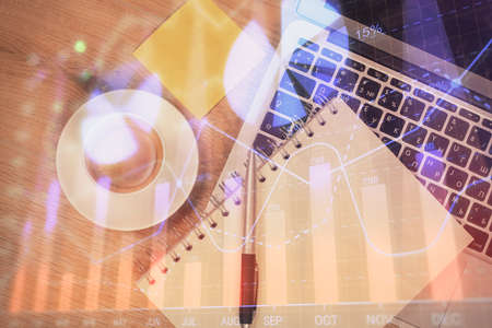 Double exposure of forex chart drawing over table background with computer. Concept of financial research and analysis. Top view.の写真素材