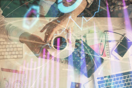 Double exposure of man and woman working together and financial chart hologram drawing. market analysis concept. Computer background. Top View.の写真素材