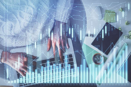 Multi exposure of woman hands working on computer and forex chart hologram drawing. Top View....
