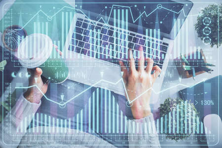 Double exposure of woman hands working on computer and forex chart hologram drawing. Top View....