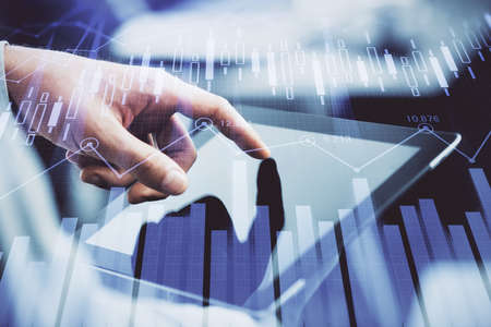 Multi exposure of mans hands holding and using a phone and financial chart drawing. Market analysis...