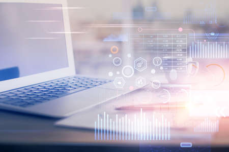 Double exposure of table with computer on background and data theme hologram. Data technology...