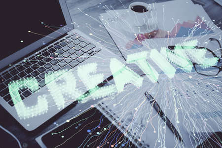 Desktop computer background in office and start up theme hologram drawing. Double exposure. Startup concept.の写真素材