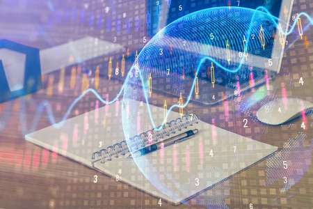 Double exposure of forex graph and work space with computer. Concept of international online...
