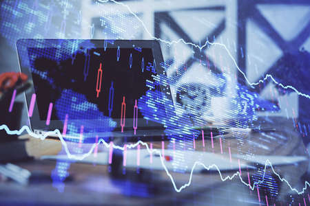 Stock market graph and table with computer background. Multi exposure. Concept of financial...