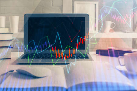 Stock market chart hologram drawn on personal computer background. Multi exposure. Concept of...