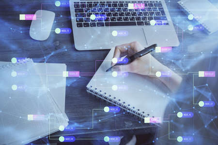 Multi exposure of writing hands on background with data solution hologram. Technology concept.