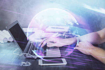Technology theme hologram with man working on computer on background. High tech concept. Double exposure.の写真素材