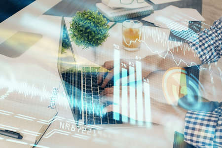Technology theme hologram with man working on computer on background. High tech concept. Multi...
