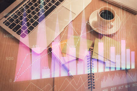 Stock market graph and top view computer on the table background. Double exposure. Concept of financial education.の写真素材