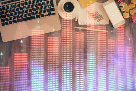 Financial market graph and top view computer on the desktop background. Double exposure. Investment concept.の写真素材