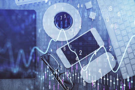 Multi exposure of forex graph hologram over desktop with phone. Top view. Mobile trade platform...
