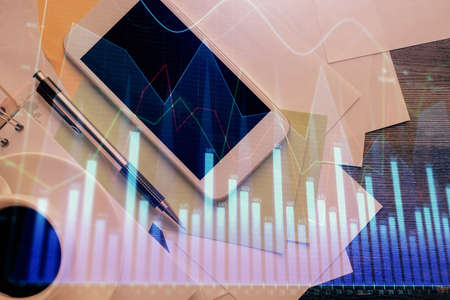 Multi exposure of forex graph hologram over desktop with phone. Top view. Mobile trade platform concept.の写真素材