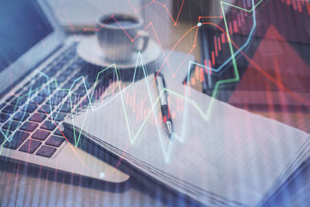 Double exposure of forex chart drawing and desktop with coffee and items on table background....