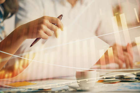 Double exposure of forex graph drawing over people taking notes background. Concept of financial...