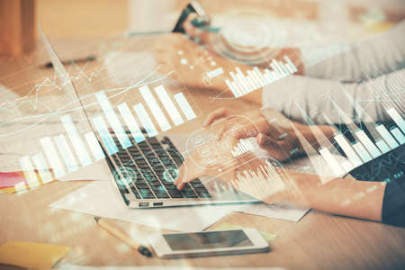 Multi exposure of woman hands typing on computer and financial chart hologram drawing. Stock market...