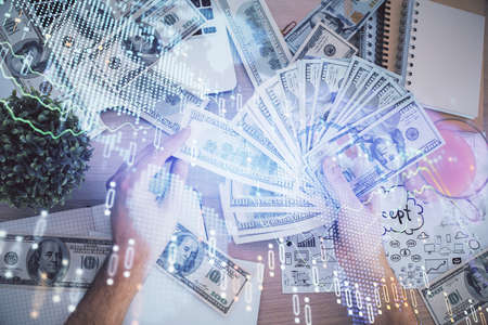 Multi exposure of financial graph drawing hologram and USA dollars bills and man hands. Analysis...