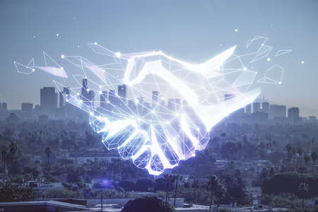 Double exposure of handshake hologram over city view background. Concept of partnership.