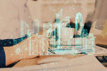 Abstract holographic city on mans hand writing notes background. Multi exposure.の写真素材