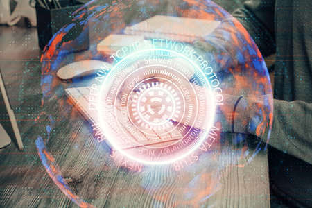 Technology theme hologram with man working on computer on background. High tech concept. Double exposure.の写真素材