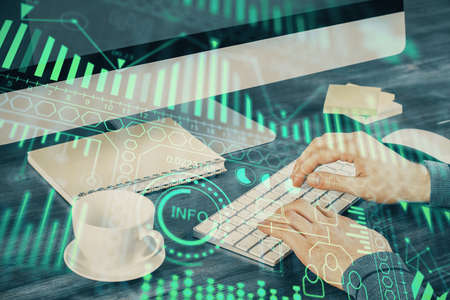 Technology theme hologram with man working on computer on background. High tech concept. Multi...