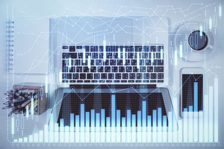 Stock market chart and top view computer on the table background. Multi exposure. Concept of...