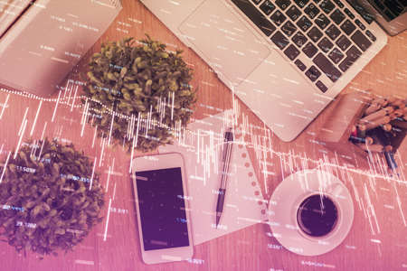 Multi exposure of financial chart hologram over desktop with phone. Top view. Mobile trade platform concept.の写真素材