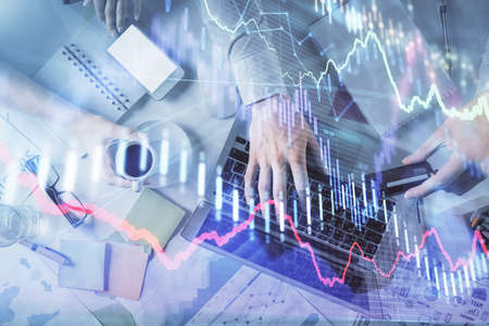 Double exposure of man and woman working together and forex graph hologram drawing. Financial...
