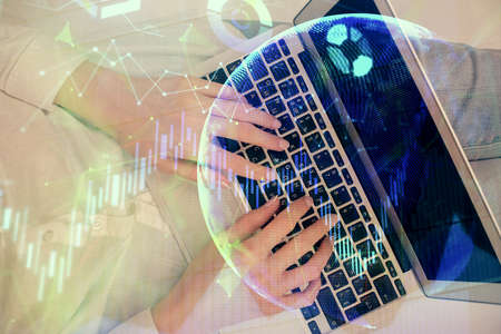 Double exposure of woman hands working on computer and forex chart hologram drawing. Top View....