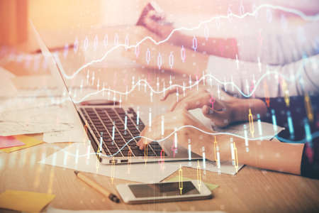 Multi exposure of woman hands typing on computer and financial chart hologram drawing. Stock market...