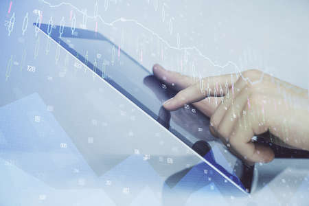 Multi exposure of mans hands holding and using a digital phone and forex graph drawing. Financial market concept.の写真素材