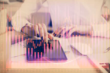 Double exposure of forex chart sketch hologram and woman holding and using a mobile device....