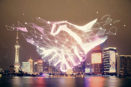 Double exposure of handshake hologram over city view background. Concept of partnership.の写真素材