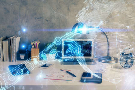 Computer on desktop in office with technology theme hologram. Double exposure. Tech concept.の写真素材