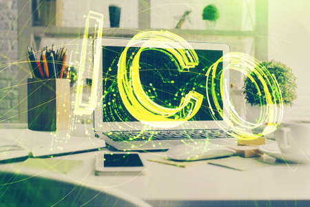 Multi exposure of blockchain and crypto economy theme hologram and table with computer background. Concept of bitcoin cryptocurrency.の写真素材