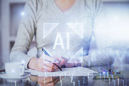 Double exposure of writing hand on background with data solution technology hologram. Ai concept.の写真素材