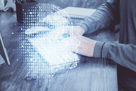 Man typing on keyboard background with brain hologram. Concept of big Data. Double exposure.