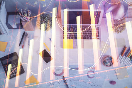 Double exposure of forex chart drawing over table background with computer. Concept of financial...