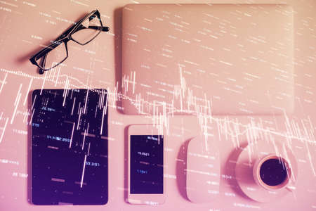 Multi exposure of financial chart hologram over desktop with phone. Top view. Mobile trade platform concept.の写真素材