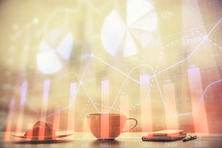 Double exposure of forex chart over coffee cup background in office. Concept of financial analysis...