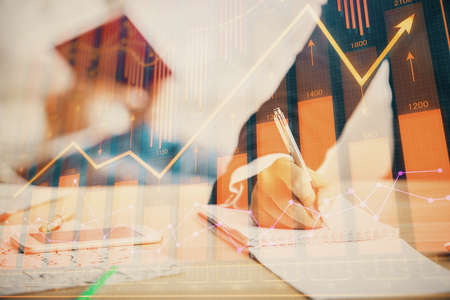 Double exposure of forex chart drawing over people taking notes background. Concept of financial...