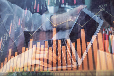 Double exposure of woman hands typing on computer and forex chart hologram drawing. Stock market...