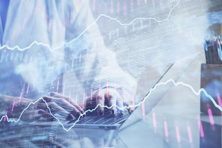 Double exposure of woman hands typing on computer and forex chart hologram drawing. Stock market...