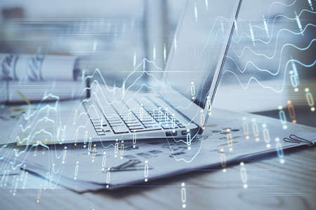 Stock market graph on background with desk and personal computer. Multi exposure. Concept of...