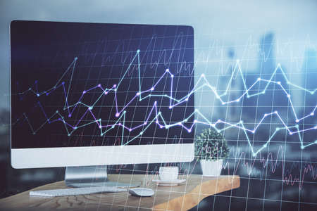 Double exposure of graph and financial info and work space with computer background. Concept of international online trading.の写真素材