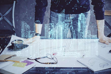 Abstract holographic city on mans hand writing notes background. Double exposure.