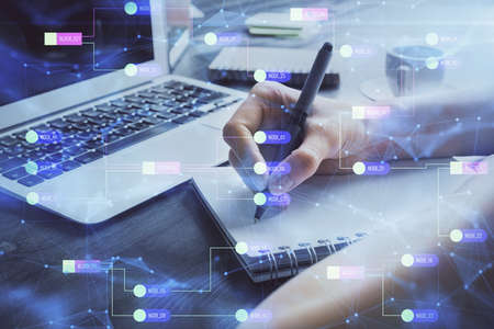 Multi exposure of writing hands on background with data solution hologram. Technology concept.
