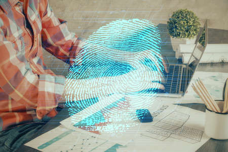 Fingerprint hologram with businessman working on computer on background. Security concept. Double exposure.の写真素材