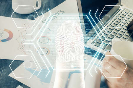 Fingerprint hologram with businessman working on computer on background. Security concept. Double...