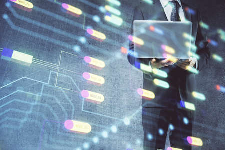 Double exposure of data internet theme hologram with man working on computer on background. Concept...